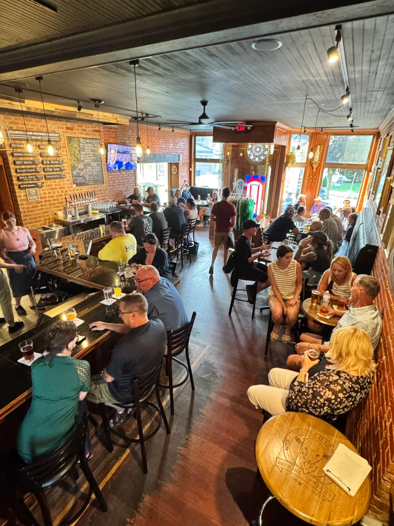 Guests enjoying drinks and conversation in the Bearded Lamb taproom